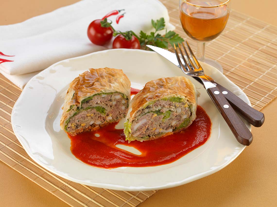 Savoy cabbage and goose strudel in spicy tomato sauce Savoy cabbage and goose strudel in spicy tomato sauce